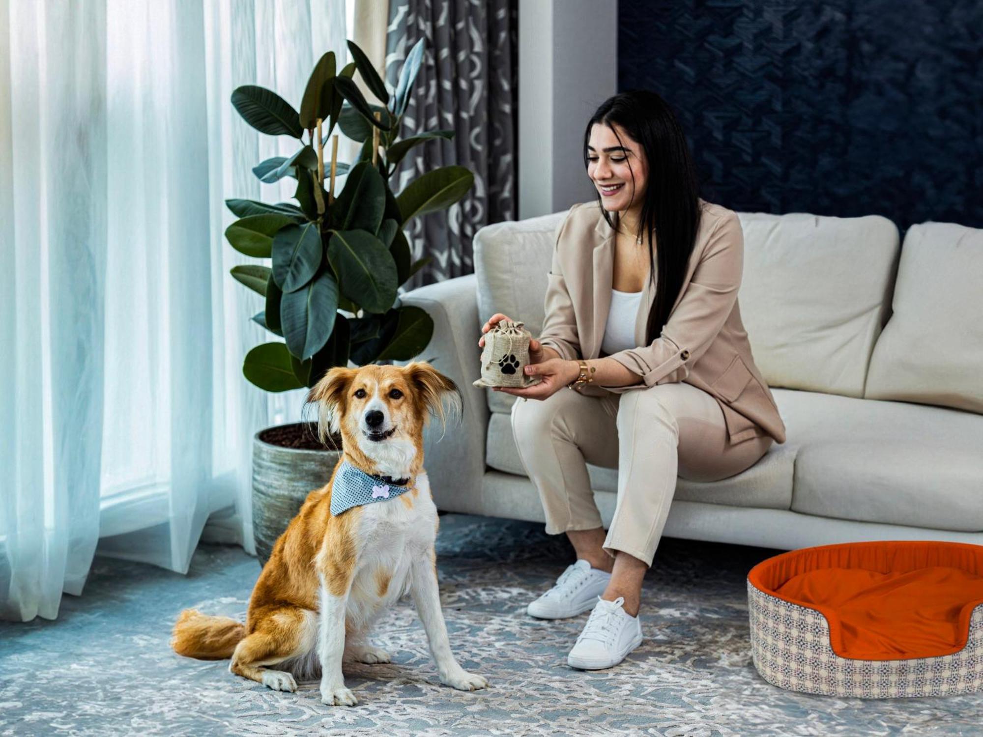 Abesq Doha Hotel And Residences, An Ihg Hotel Экстерьер фото A dog with its owner